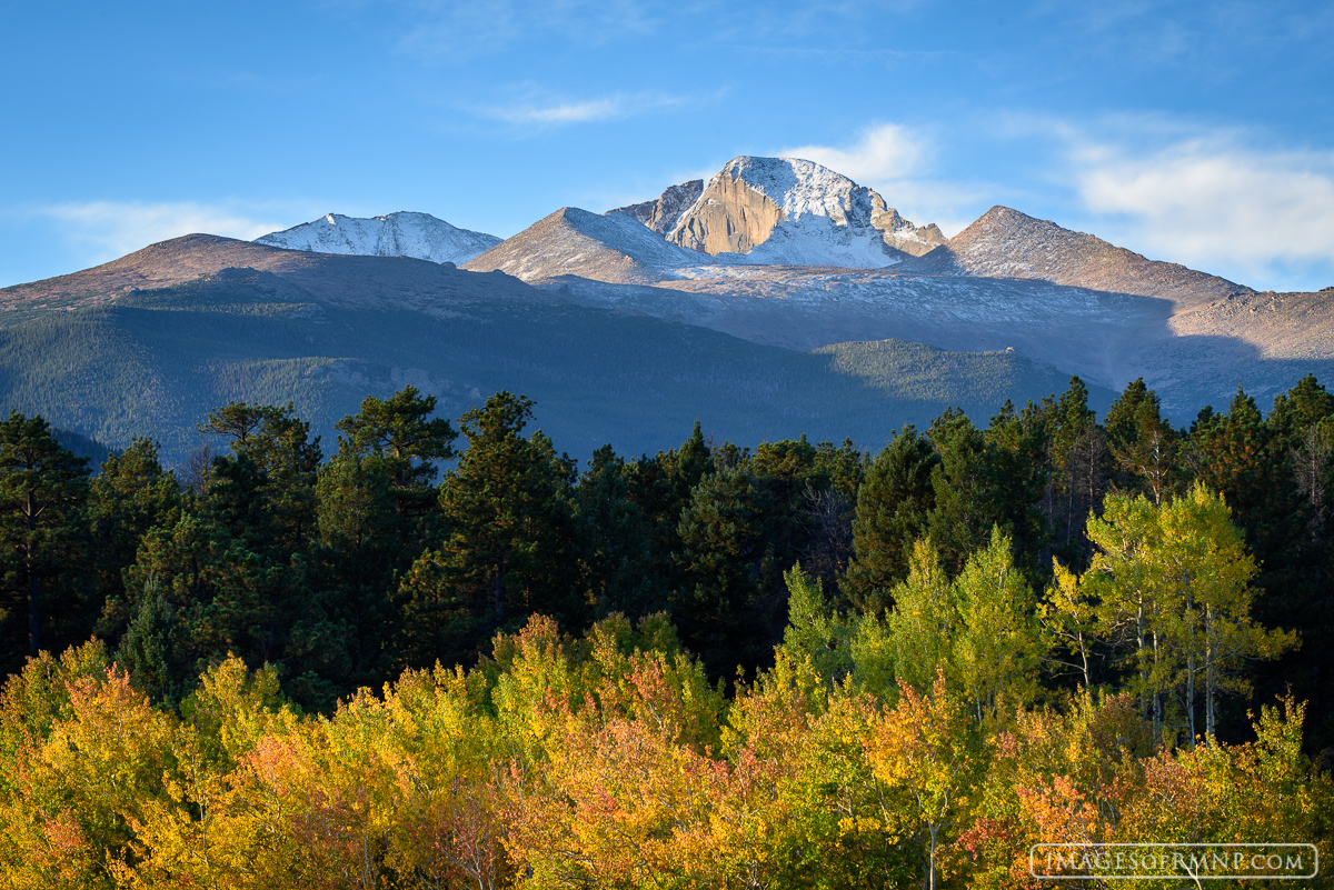 Fresh snow on Longs Peak with aspen clothed in their autumn colors below makes for a perfect autumn day in Rocky Mountain National...