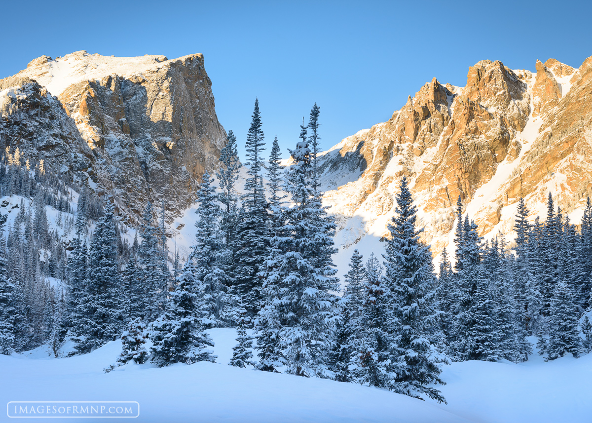 A calm morning with bluebird colored skies following a winter snow storm near Dream Lake.