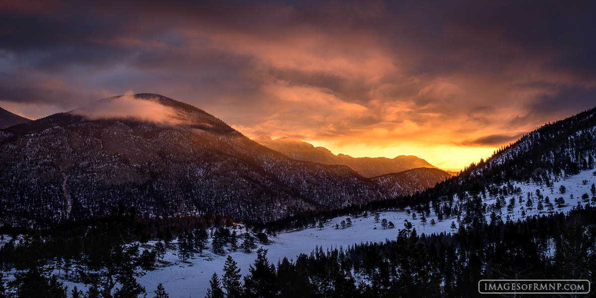 The sun briefly works its magic on the low-lying clouds at the start of a new day in Rocky Mountain National Park.