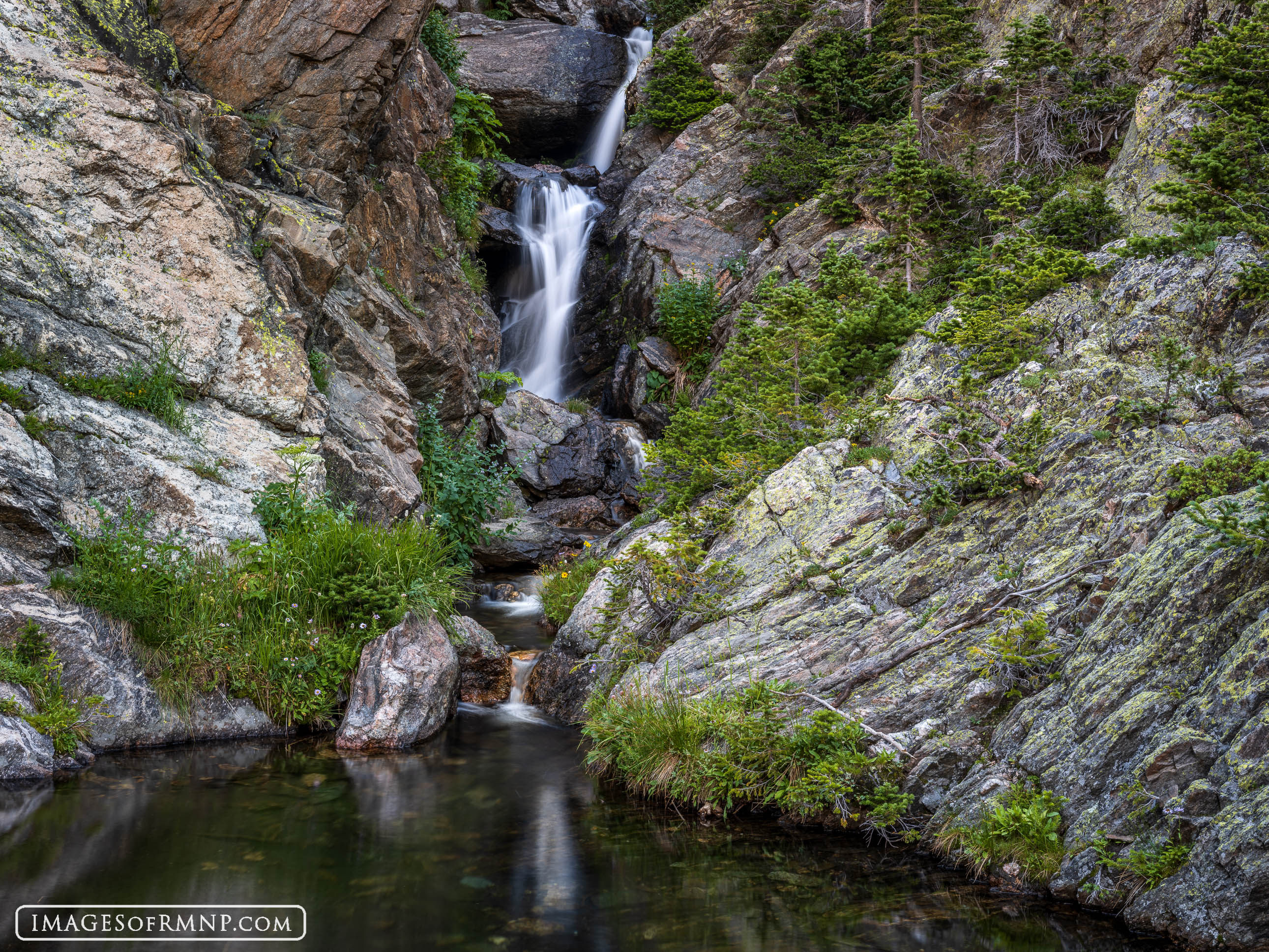 Well before you arrive at this scene you can hear the sound of falling water. Its voice is amplified by the surrounding rocks...