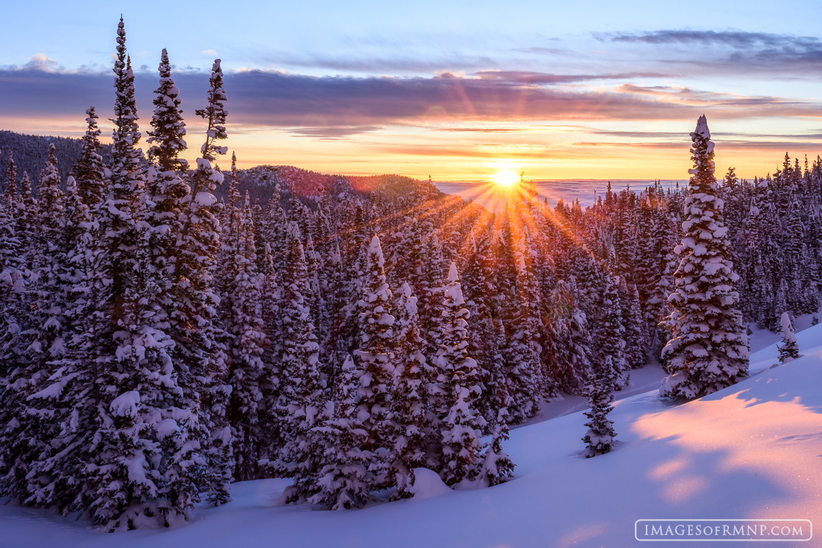 The sun finally arises following a large spring snowstorm which covered the mountains in over two feet of fresh white powder....