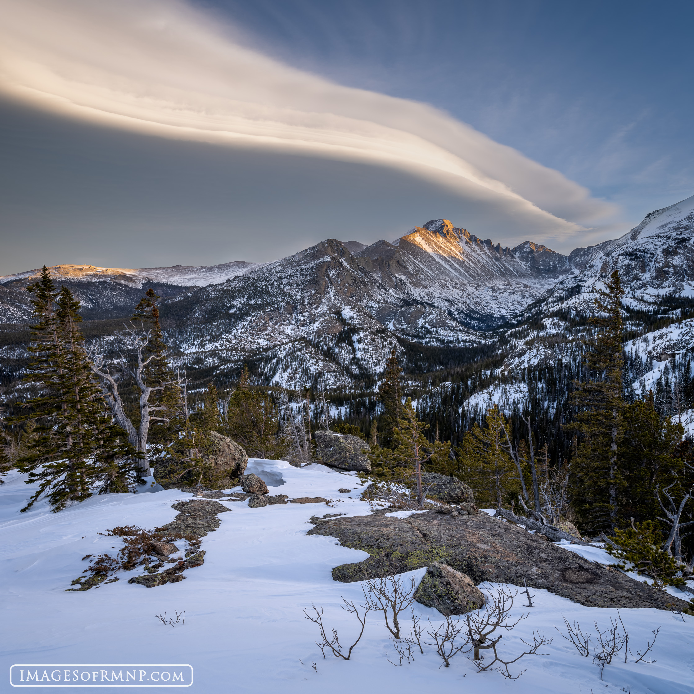 A beautiful lenticular cloud rested over Longs Peak and Glacier Gorge on this February evening. As the sun set, it illuminated...