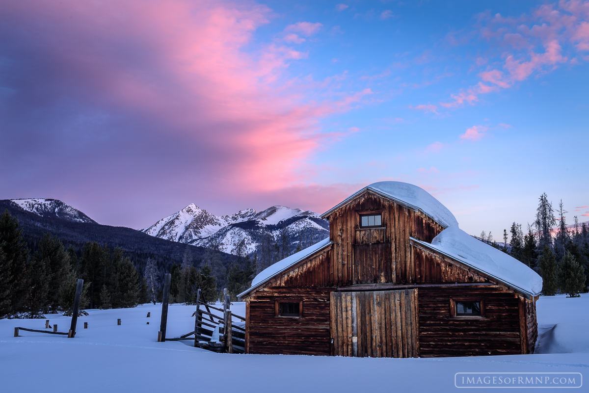 On an early winter morning the clouds above Mount Baker begin to glow at the start of a new day.  Down in the valley below an...