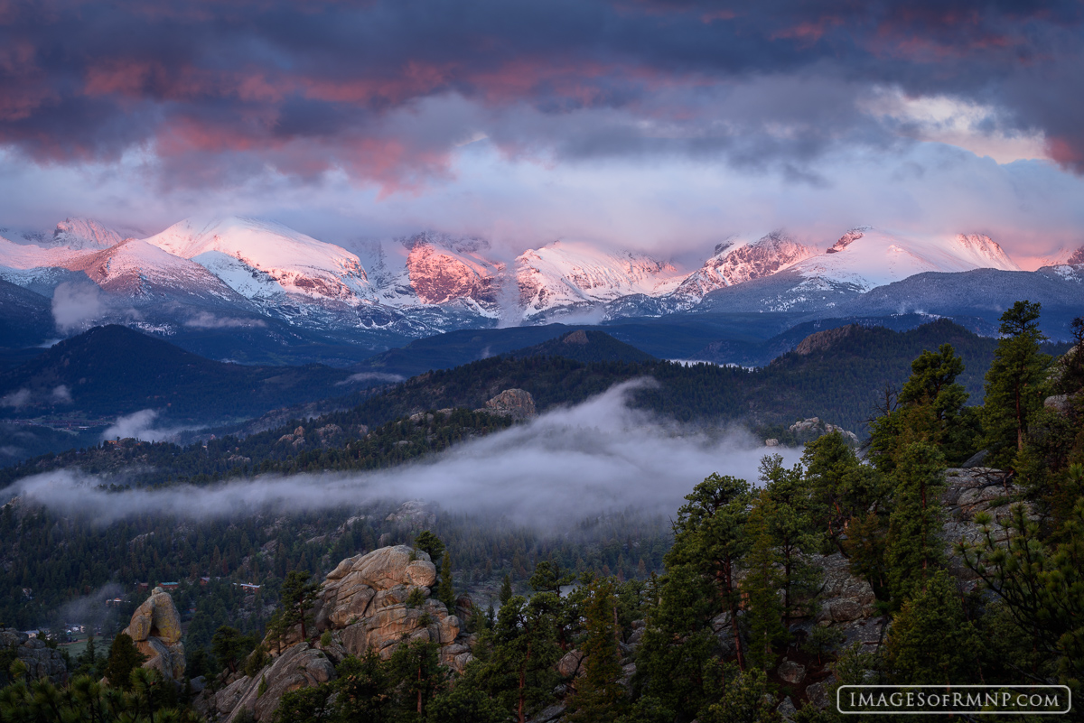 The clouds part at sunrise, just enough to get a glimpse of the Continental Divide from Lumpy Ridge.