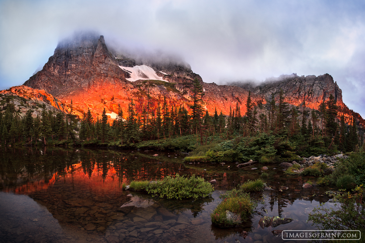 On this morning clouds blanketed the peaks and there seemed to be little chance of a sunrise, yet somehow the sun found an opening...