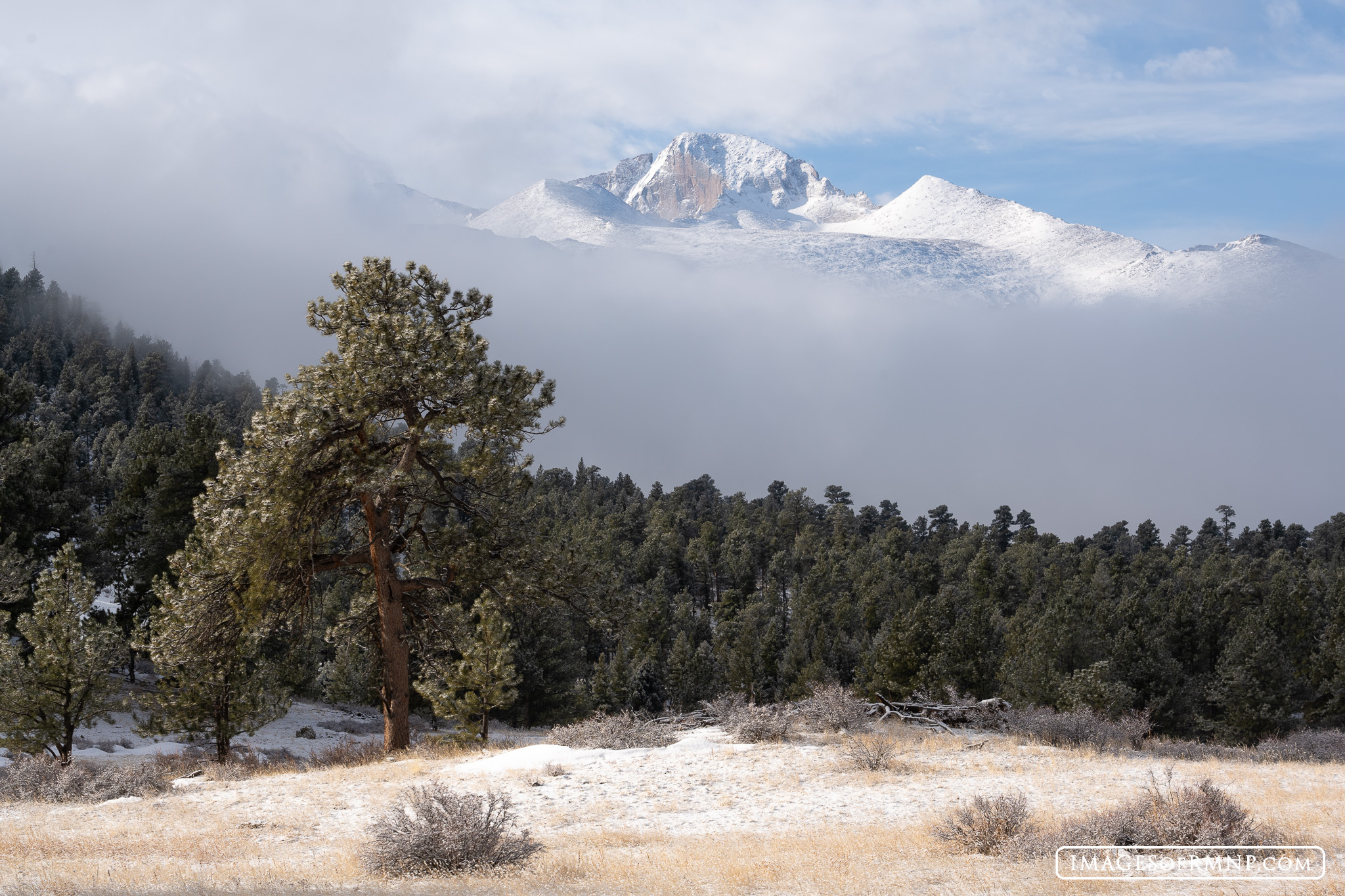 Longs Peak appears briefly as a winter storm begins to move up from the valley and into the national park. Just 24 hours later...