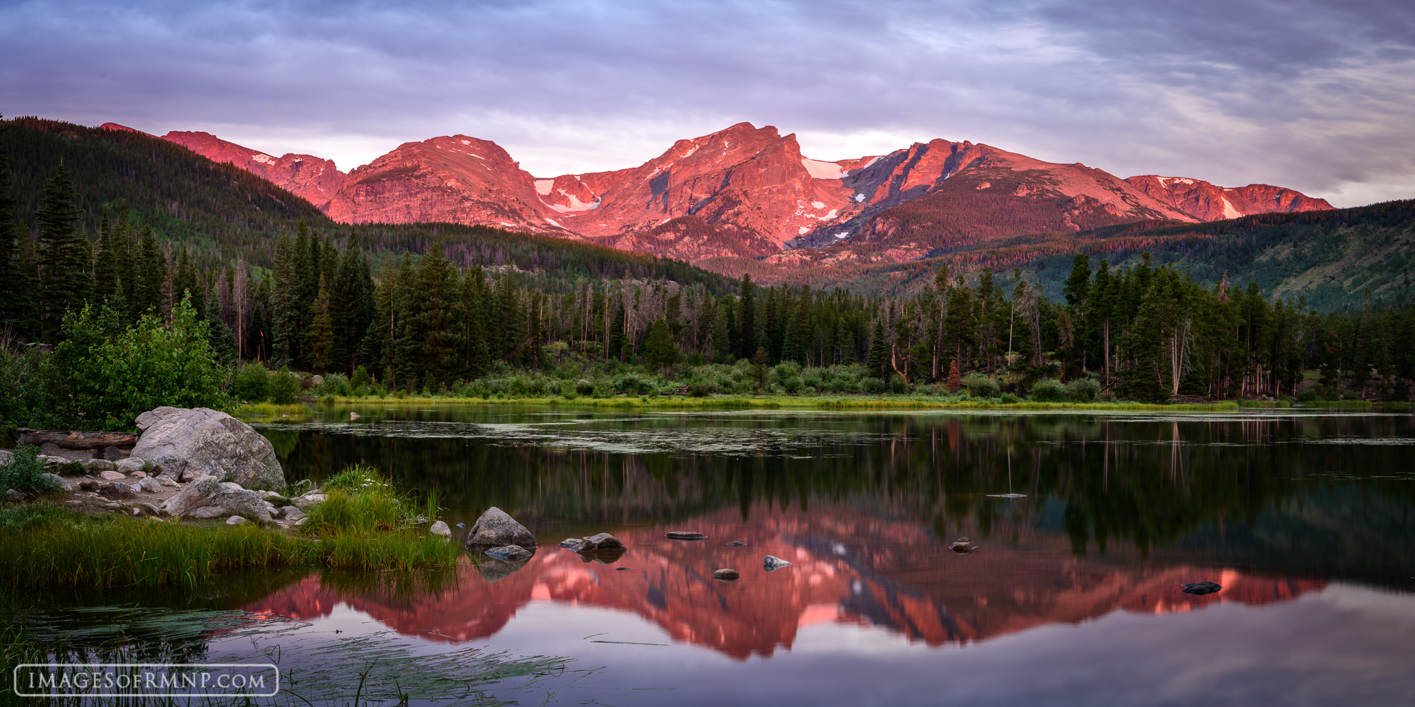 On this peaceful summer morning at Sprague Lake the wind held its breath as the mountains glowed in the warm gentle light of...