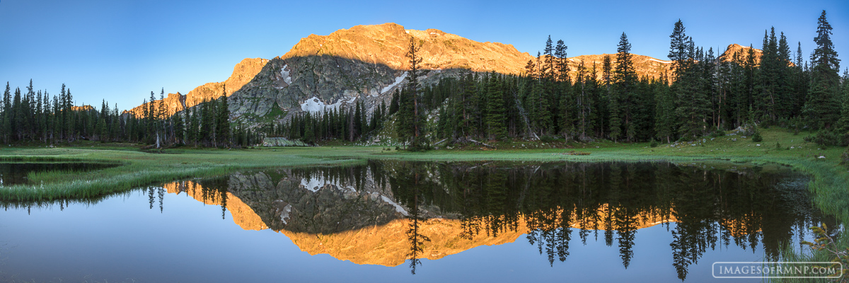 There was not a breath of wind this morning as I sat beside this small pond in Rocky Mountain National Park. In the background...