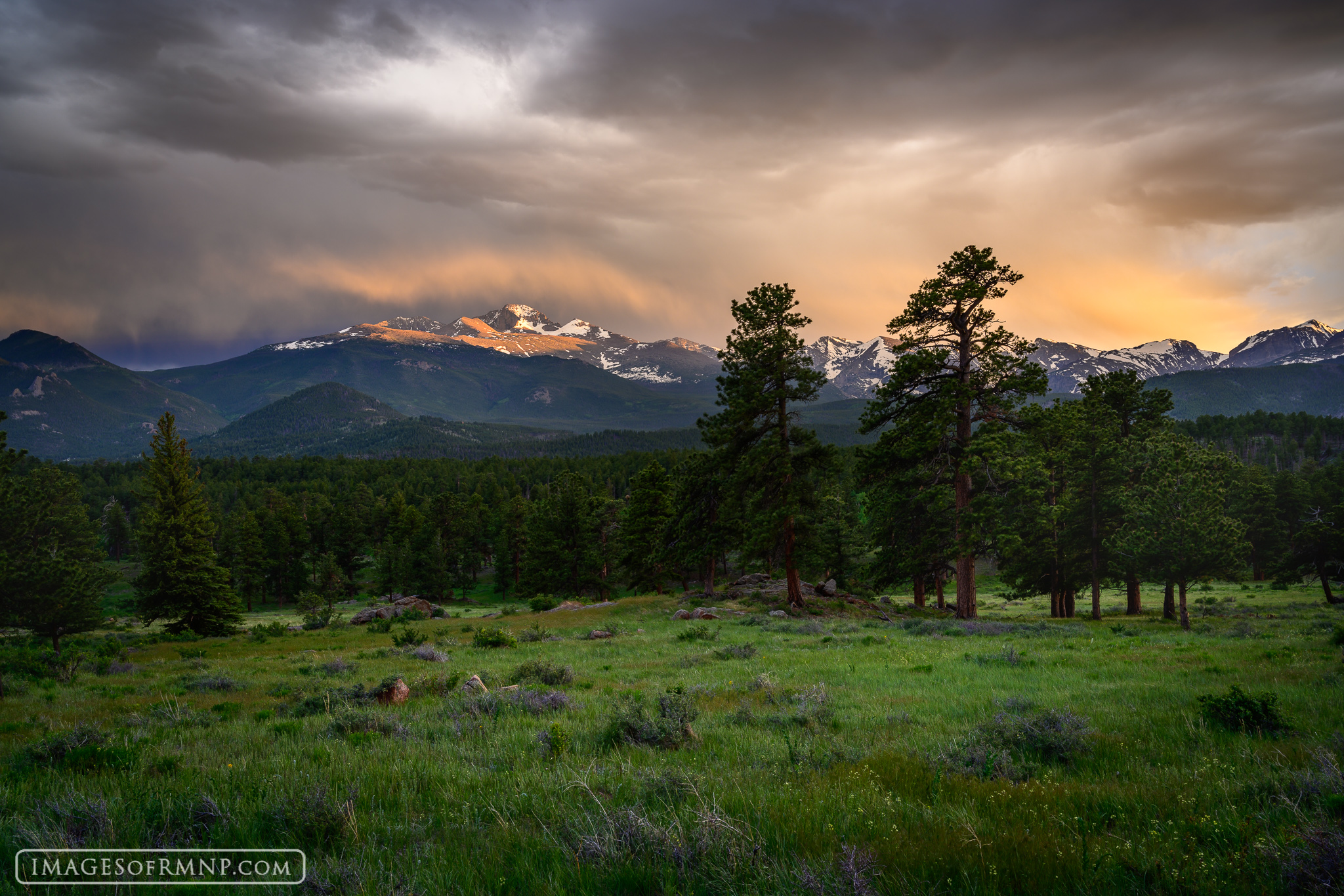 On this evening a storm moved in over Rocky Mountain National Park at sunset. The setting sun lit the falling rain over Longs...