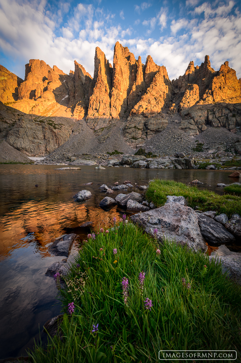 The spires towering over Sky Pond catch the first light of the day on a warm July morning.