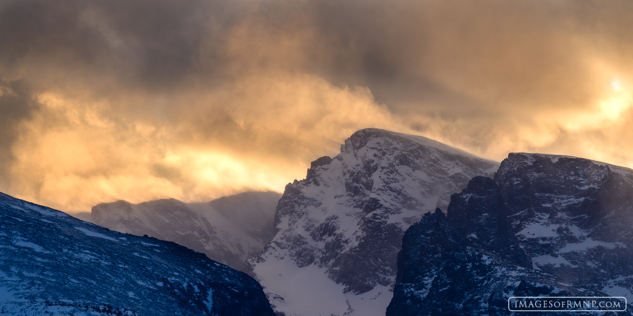A winter storm blows over Taylor Peak as the sun sets behind it.