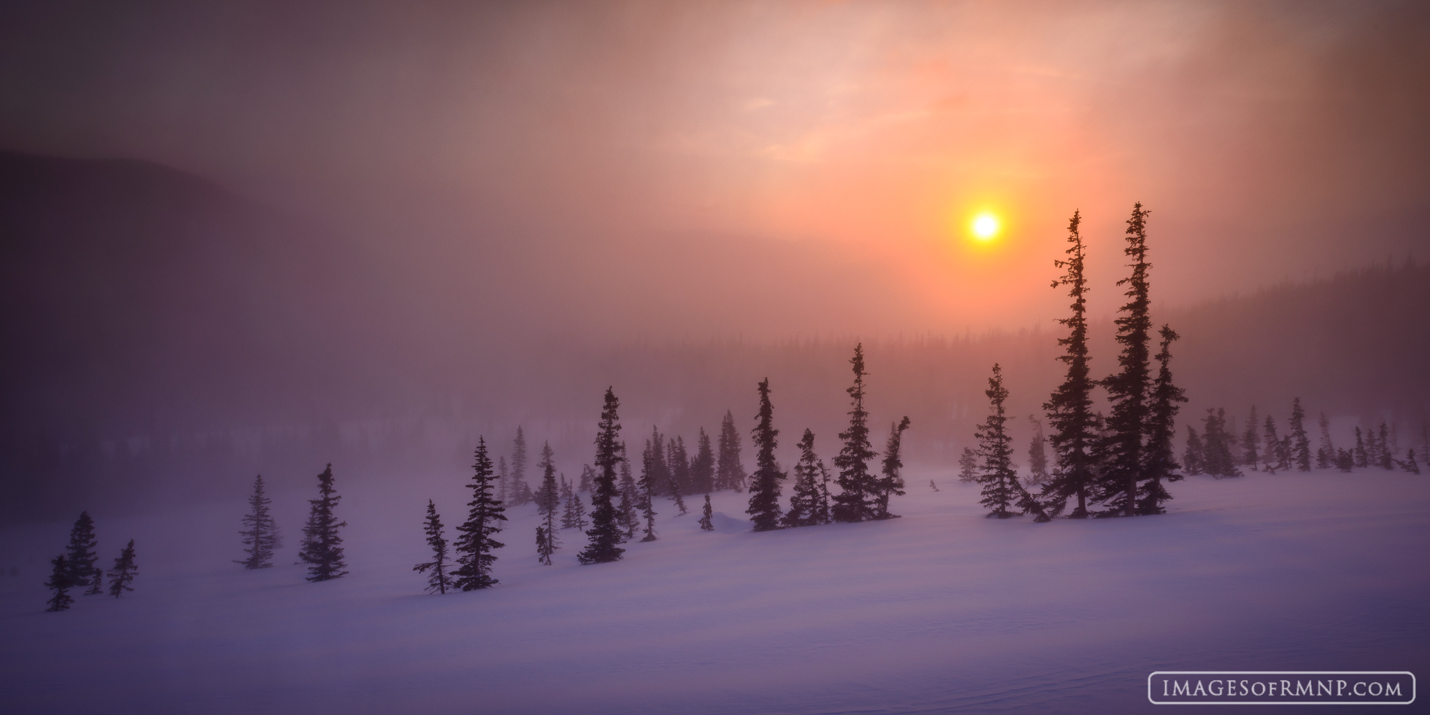 Blowing snow and sunrise on the side of Flattop Mountain