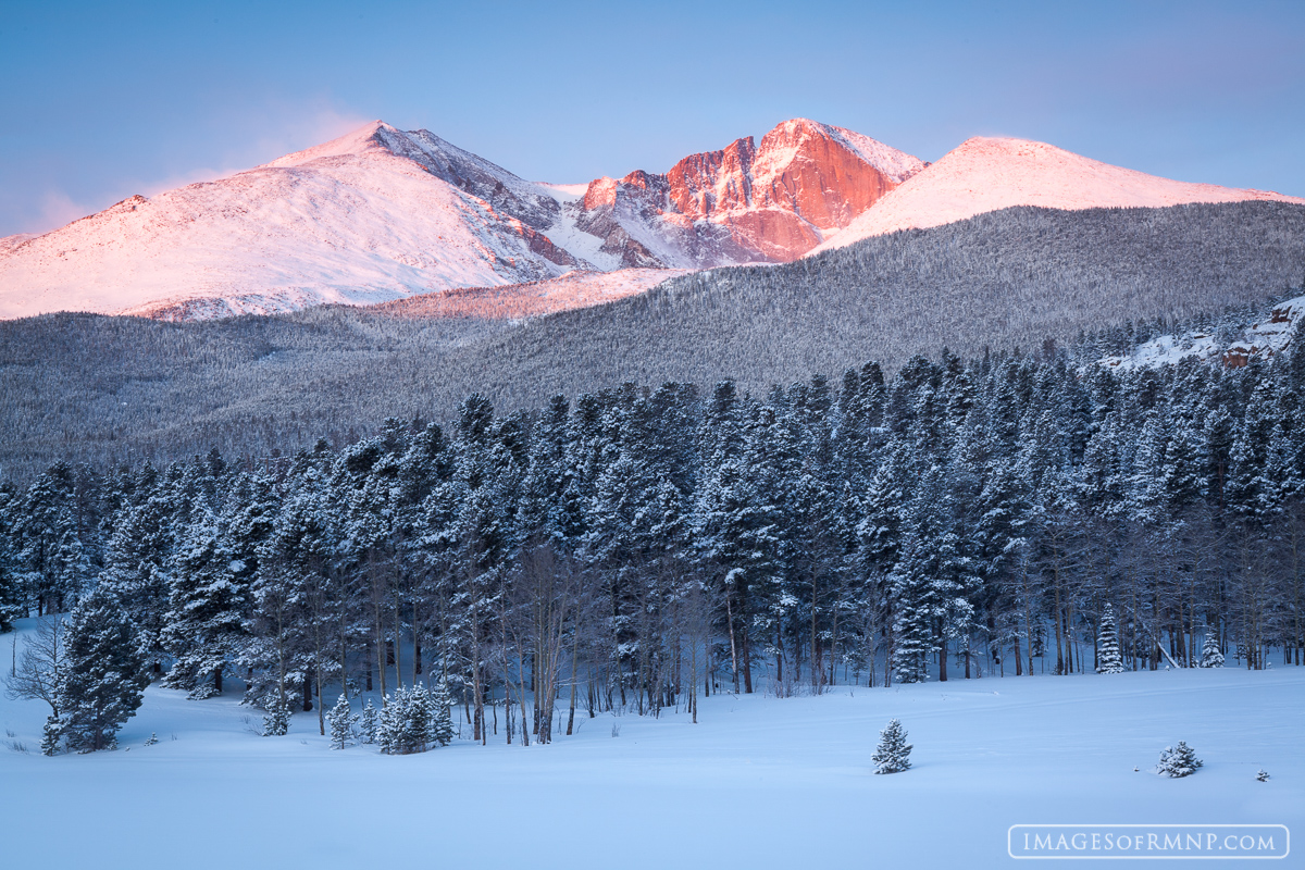 A beautiful March sunrise on Longs Peak with fresh snow and alpenglow.